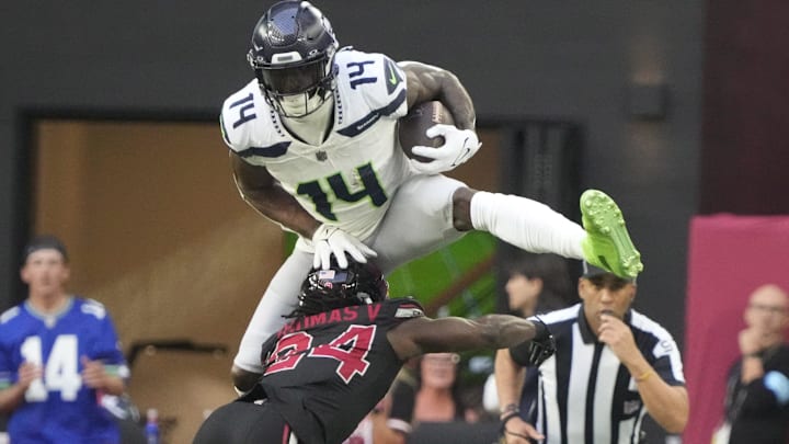 Seattle Seahawks wide receiver DK Metcalf (14) jumps over Arizona Cardinals cornerback Starling Thomas V (24) during the second quarter at State Farm Stadium in Glendale on Dec. 8, 2024.