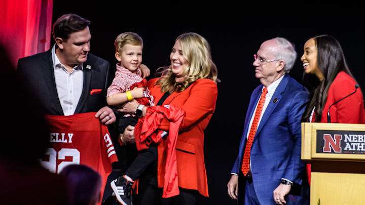 Dani Busboom Kelly holds her son Boone before speaking to the crowd. 