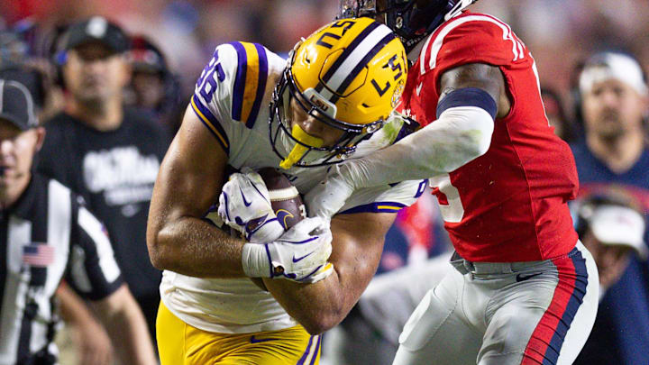 LSU Tigers tight end Mason Taylor (86) makes a first down against Ole Miss Rebels cornerback Trey Amos (9) during the second half at Tiger Stadium.