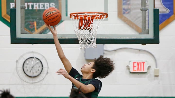 Washington sophomore Steven Reynolds puts up a reverse layup during a Class 3A, Sectional 19 boys basketball quarterfinal game against Marian Tuesday, Feb. 27, 2024, at Washington High School in South Bend.