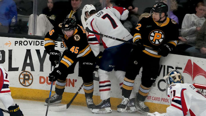 Providence Bruins center Fraser Minten and forward Fabian Lysell fighting for possession against Thundrbird Leo Loofin the second period. Providence Bruins center Fraser Minten and forward Fabian Lysell fighting for possession against Thundrbird Leo Loofin the second period.