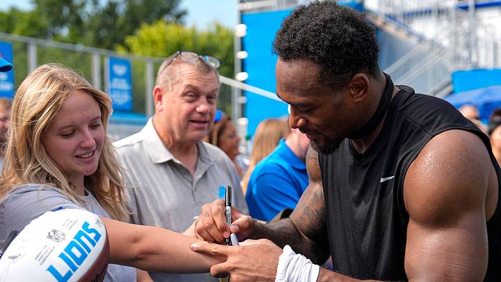 Detroit Lions linebacker Derrick Barnes (55) signs autographs for fans after practice during training camp Detroit Lions linebacker Derrick Barnes (55) signs autographs for fans after practice during training camp