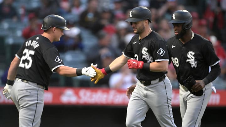 Chicago White Sox first baseman Andrew Vaughn (25) celebrates with left fielder Andrew Benintendi (23) and center fielder Luis Robert Jr. (88) at Angel Stadium. 