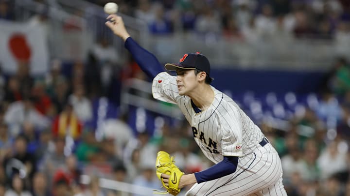 Mar 20, 2023; Miami, Florida, USA; Japan starting pitcher Roki Sasaki (14) delivers a pitch during the first inning against Mexico at LoanDepot Park