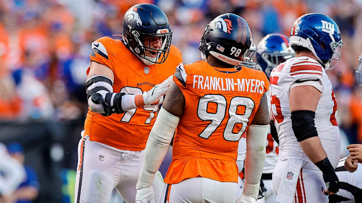 Oct 19, 2025; Denver, Colorado, USA; Denver Broncos defensive end Zach Allen (99) celebrates his sack with defensive end John Franklin-Myers (98) in the fourth quarter against the New York Giants at Empower Field at Mile High. 