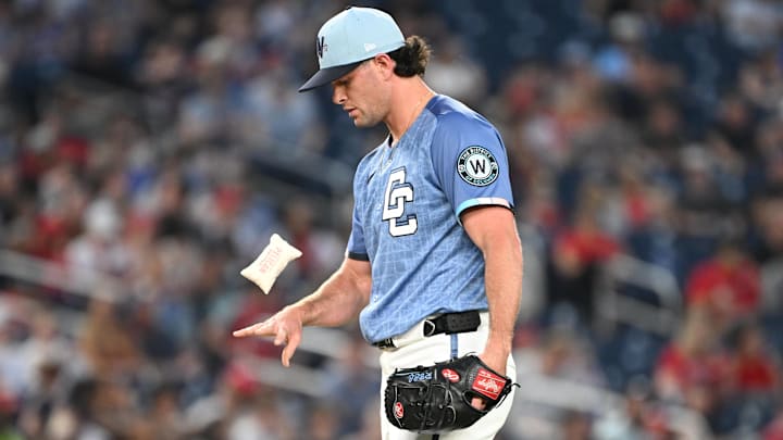 Jun 6, 2025; Washington, District of Columbia, USA; Washington Nationals relief pitcher Kyle Finnegan (67) tosses the rosin bag before a pitch during the ninth inning against the Texas Rangers at Nationals Park.
