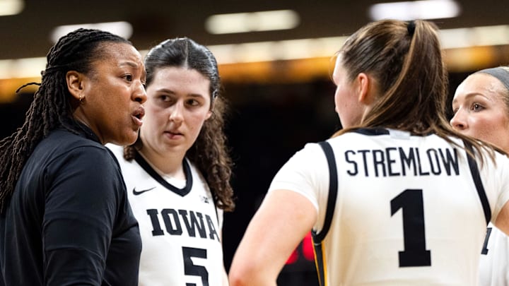 Iowa assistant coach Lasondra Barrett huddles with Iowa’s Ava Heiden (5), Taylor Stremlow (1) and Kylie Feuerbach (4) during a game against the Illinois Fighting Illini Feb. 26, 2026 at Carver-Hawkeye Arena in Iowa City, Iowa. Iowa assistant coach Lasondra Barrett huddles with Iowa’s Ava Heiden (5), Taylor Stremlow (1) and Kylie Feuerbach (4) during a game against the Illinois Fighting Illini Feb. 26, 2026 at Carver-Hawkeye Arena in Iowa City, Iowa.