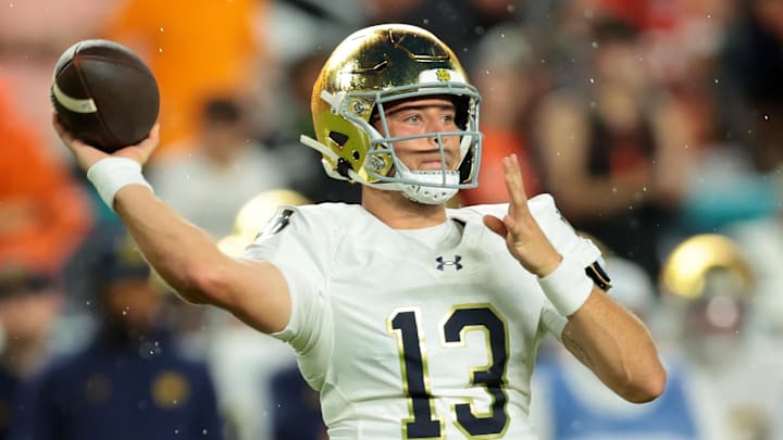 Aug 31, 2025; Miami Gardens, Florida, USA; Notre Dame Fighting Irish quarterback CJ Carr (13) drops back to pass against the Miami Hurricanes during the first quarter at Hard Rock Stadium. 