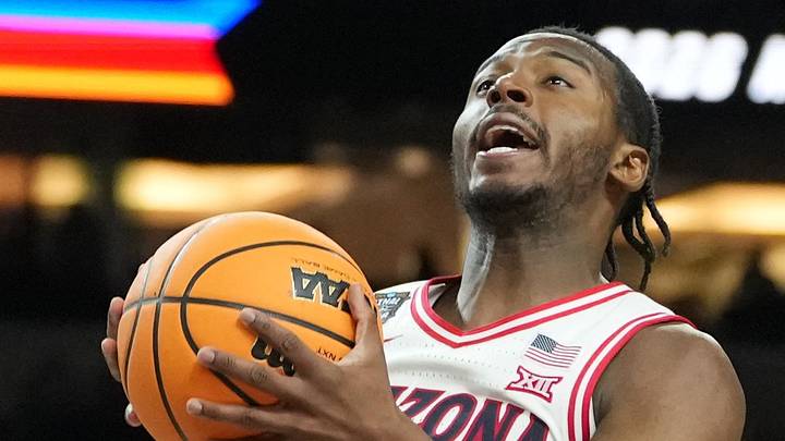 Arizona Wildcats guard Jaden Bradley shoots against Michigan Wolverines forward Morez Johnson Jr.