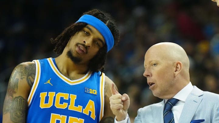 Mar 8, 2025; Los Angeles, California, USA; UCLA Bruins head coach Mick Cronin (center) talks with guard Skyy Clark (55) and guard Lazar Stefanovic (10) in the second half against the Southern California Trojans at Pauley Pavilion presented by Wescom. Mandatory Credit: Kirby Lee-Imagn Images