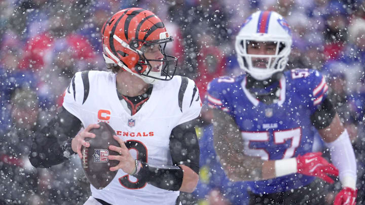 Cincinnati Bengals quarterback Joe Burrow runs away from Buffalo Bills defensive end AJ Epenesa and gets off a pass during first half action at Highmark Stadium in Orchard Park on Dec. 7, 2025.
