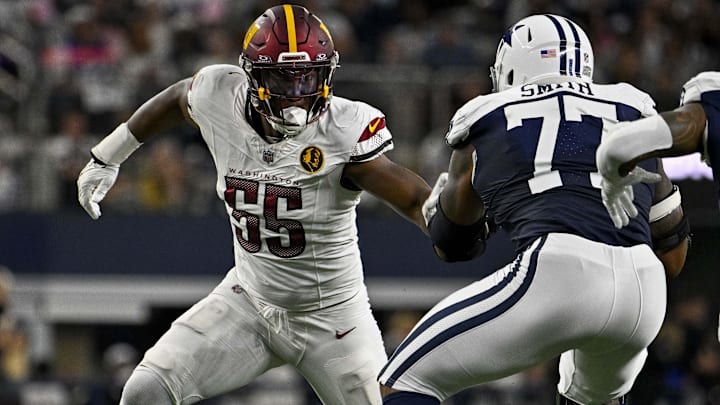 Washington Commanders defensive end KJ Henry and Dallas Cowboys offensive tackle Tyron Smith in action during the game between the NFC East rivals. Washington Commanders defensive end KJ Henry and Dallas Cowboys offensive tackle Tyron Smith in action during the game between the NFC East rivals.