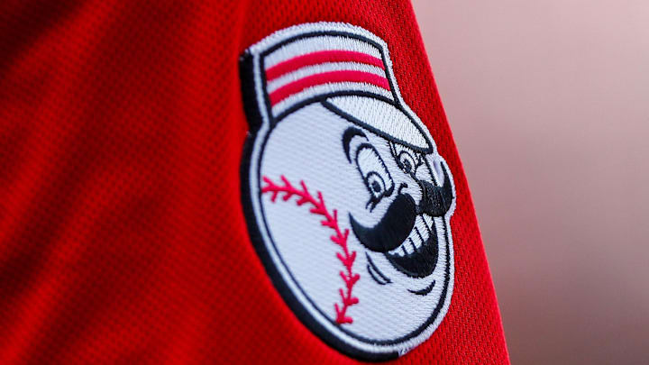 Jun 24, 2023; Cincinnati, Ohio, USA; The Cincinnati Reds logo on the sleeve of Cincinnati Reds shortstop Elly De La Cruz (44) while he prepares on deck during the fifth inning against the Atlanta Braves at Great American Ball Park. Mandatory Credit: Katie Stratman-Imagn Images Jun 24, 2023; Cincinnati, Ohio, USA; The Cincinnati Reds logo on the sleeve of Cincinnati Reds shortstop Elly De La Cruz (44) while he prepares on deck during the fifth inning against the Atlanta Braves at Great American Ball Park. Mandatory Credit: Katie Stratman-Imagn Images
