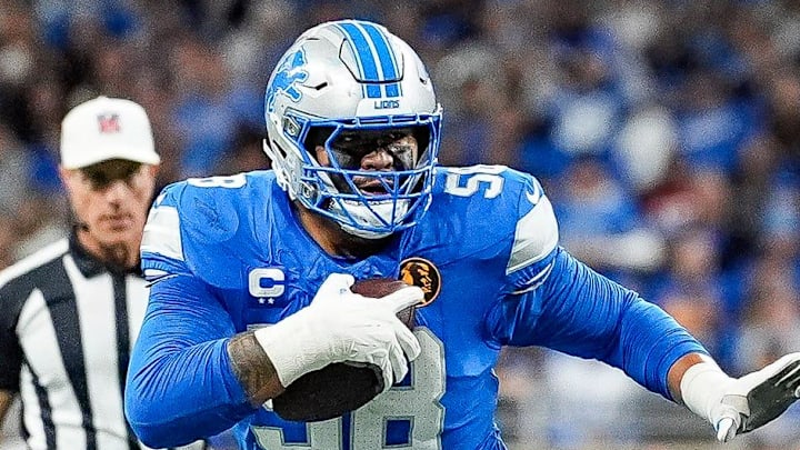 Detroit Lions offensive tackle Penei Sewell (58) carries the ball and runs against Chicago Bears linebacker Jack Sanborn (57) during the first half at Ford Field in Detroit on Thursday, Nov. 28, 2024.