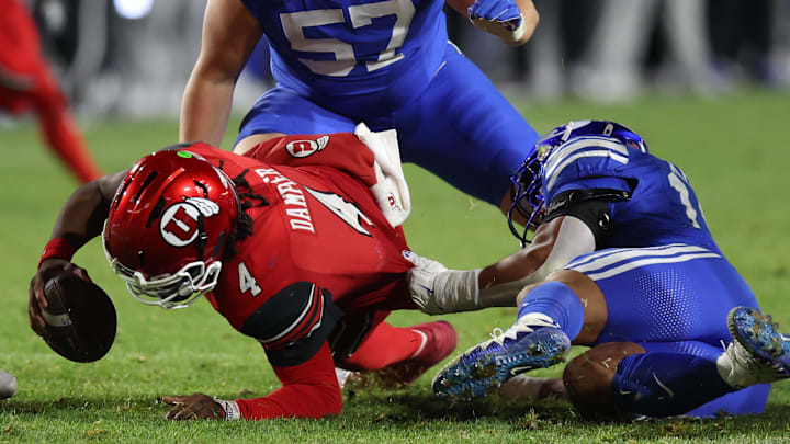 Utah Utes quarterback Devon Dampier (4) is sacked by BYU Cougars linebacker Jack Kelly (17) during the second half at LaVell Edwards Stadium.