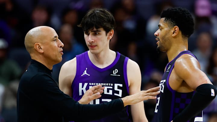 Feb 6, 2026; Sacramento, California, USA; Sacramento Kings head coach Doug Christie talks with center Dylan Cardwell (32) and center Maxime Raynaud (42) during the fourth quarter against the Los Angeles Clippers at Golden 1 Center.