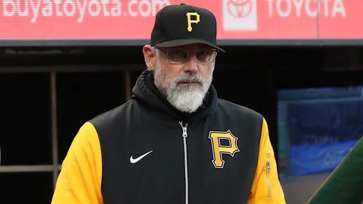 Apr 16, 2025; Pittsburgh, Pennsylvania, USA;  Pittsburgh Pirates manager Derek Shelton (17) watches the action from the dugout against the Washington Nationals during the fourth inning at PNC Park