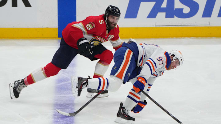 Aaron Ekblad battles Connor McDavid for the puck during the 2025 Stanley Cup Final.