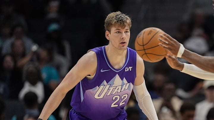 Mar 31, 2025; Charlotte, North Carolina, USA; Utah Jazz forward Kyle Filipowski (22) watches Charlotte Hornets center Mark Williams (5) as he passes the ball during the second half at Spectrum Center. Mandatory Credit: Jim Dedmon-Imagn Images