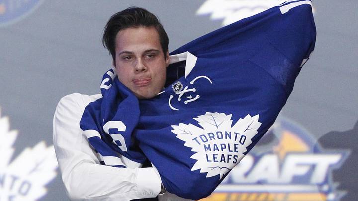 Jun 24, 2016; Buffalo, NY, USA; Auston Matthews puts on a team jersey after being selected as the number one overall draft pick by the Toronto Maple Leafs in the first round of the 2016 NHL Draft at the First Niagra Center. Mandatory Credit: Timothy T. Ludwig-Imagn Images