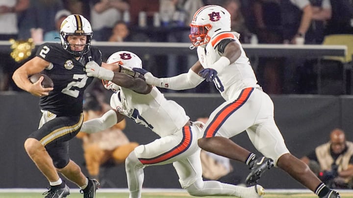 Vanderbilt quarterback Diego Pavia (2) is stopped by Auburn linebacker Xavier Atkins (17) and defensive end Amaris Williams (10) during the third quarter at FirstBank Stadium in Nashville, Tenn., Saturday, Nov. 8, 2025.