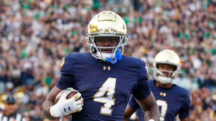 Notre Dame running back Jeremiyah Love (4) runs the ball into the end zone for a touchdown in the first half of a NCAA football game against Syracuse at Notre Dame Stadium on Saturday, Nov. 22, 2025, in South Bend. Notre Dame running back Jeremiyah Love (4) runs the ball into the end zone for a touchdown in the first half of a NCAA football game against Syracuse at Notre Dame Stadium on Saturday, Nov. 22, 2025, in South Bend.