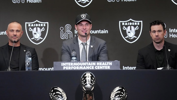 Apr 24, 2026; Henderson, NV, USA; Las Vegas Raiders quarterback Fernando Mendoza (center) speaks at introductory press conference at Intermountain Health Performance Center flanked by general manager John Spytek (left) and head coach Klint Kubiak after being selected as the No. 1 pick in the 2026 NFL Draft. Mandatory Credit: Kirby Lee-Imagn Images