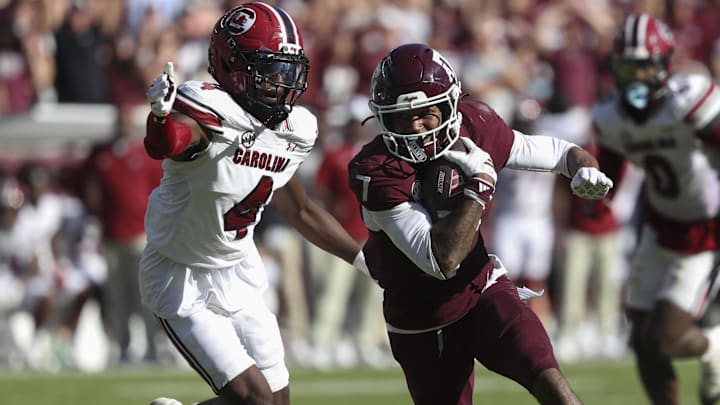 Texas A&M Aggies wide receiver KC Concepcion runs with the ball past South Carolina Gamecocks defensive back Vicari Swain.