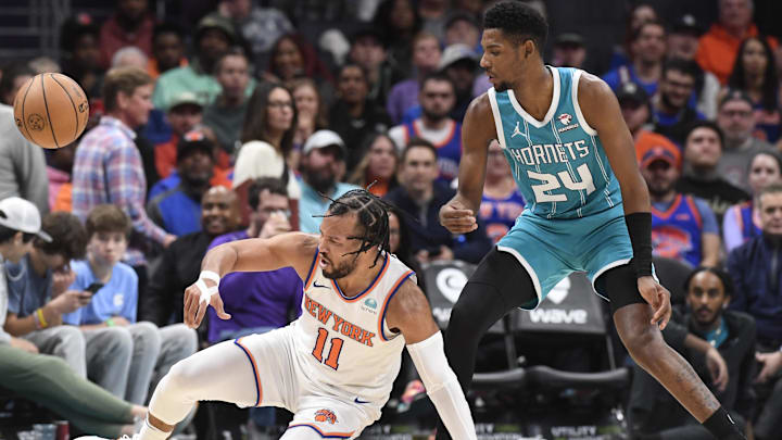 Jan 29, 2024; Charlotte, North Carolina, USA;  New York Knicks guard Jalen Brunson (11) looses the ball as he is defended by Charlotte Hornets forward guard Brandon Miller (24) during the second half at the Spectrum Center. Mandatory Credit: Sam Sharpe-Imagn Images