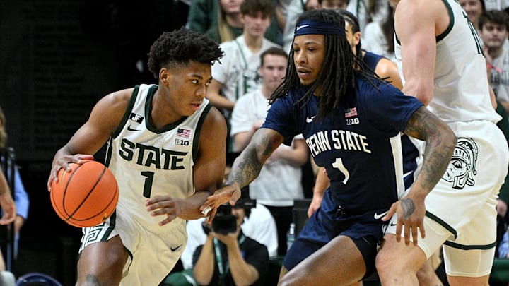 Jan 15, 2025; East Lansing, Michigan, USA;  Michigan State Spartans guard Jeremy Fears Jr. (1) drives past Penn State Nittany Lions guard Ace Baldwin Jr. (1) during the first half at Jack Breslin Student Events Center. Mandatory Credit: Dale Young-Imagn Images