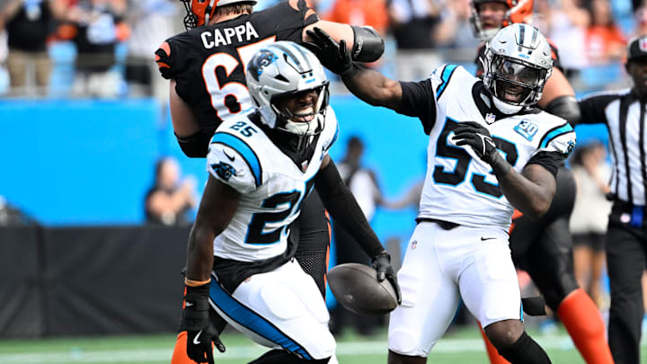 Sep 29, 2024; Charlotte, North Carolina, USA;  Carolina Panthers safety Xavier Woods (25) celebrates with  linebacker Claudin Cherelus (53) after making an interception in the fourth quarter at Bank of America Stadium. Mandatory Credit: Bob Donnan-Imagn Images