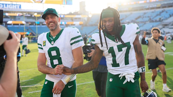 New York Jets quarterback Aaron Rodgers and wide receiver Davante Adams walk off the field after win against Jacksonville.