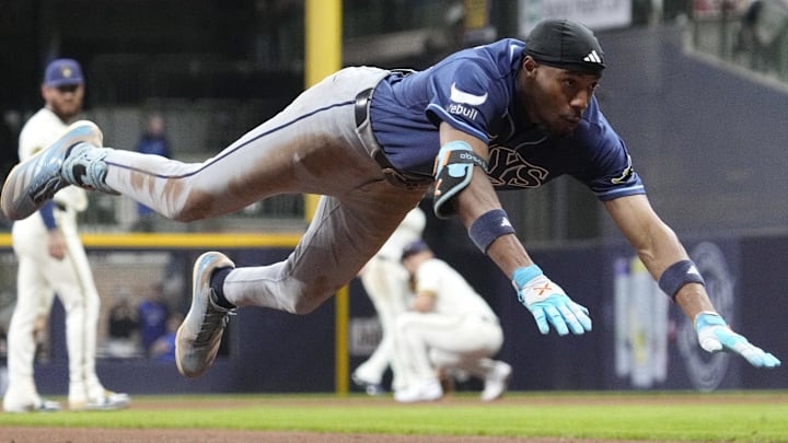Mar 31, 2026; Milwaukee, Wisconsin, USA; Tampa Bay Rays center fielder Chandler Simpson (14) slides safely into third base for a triple against the Milwaukee Brewers in the seventh inning at American Family Field.