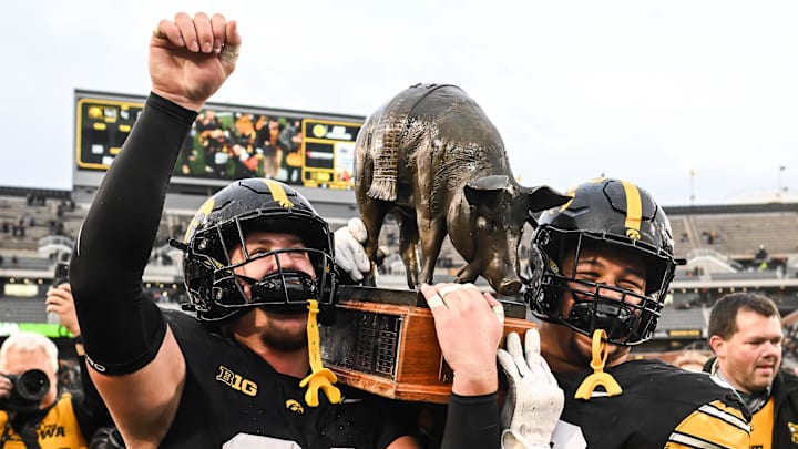 Oct 25, 2025; Iowa City, Iowa, USA; Iowa Hawkeyes defensive lineman Jonah Pace (91) and defensive lineman Bryce Hawthorne (96) carry off the Floyd of Rosedale trophy after their victory over the Minnesota Golden Gophers at Kinnick Stadium. Mandatory Credit: Jeffrey Becker-Imagn Images Oct 25, 2025; Iowa City, Iowa, USA; Iowa Hawkeyes defensive lineman Jonah Pace (91) and defensive lineman Bryce Hawthorne (96) carry off the Floyd of Rosedale trophy after their victory over the Minnesota Golden Gophers at Kinnick Stadium. Mandatory Credit: Jeffrey Becker-Imagn Images