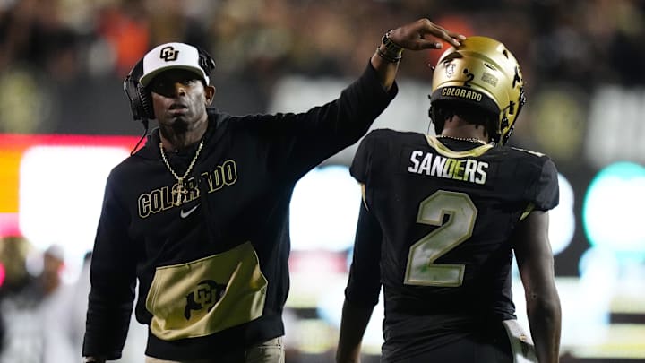 Colorado Buffaloes quarterback Shedeur Sanders (2) and head coach Deion Sanders following a two point conversion in the fourth quarter against the Colorado State Rams at Folsom Field.