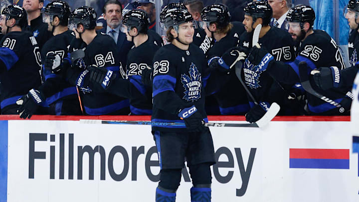 Oct 28, 2024; Winnipeg, Manitoba, CAN;  Toronto Maple Leafs forward Matthew Knies (23) is congratulated by his teammates on his goal against the Winnipeg Jets during the second period at Canada Life Centre. Mandatory Credit: Terrence Lee-Imagn Images