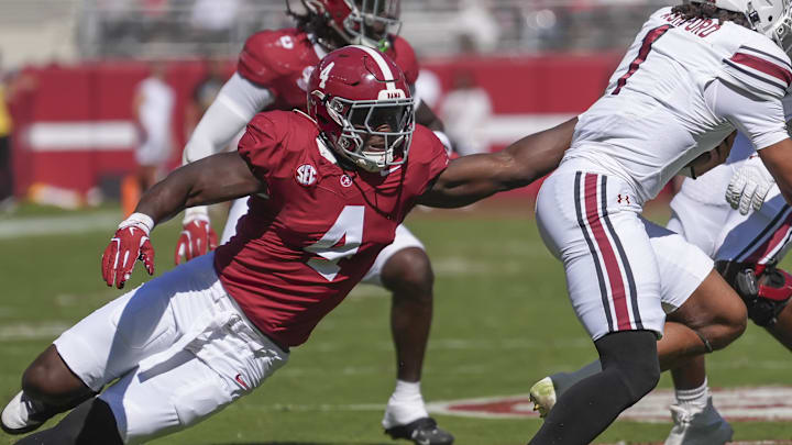 Oct 12, 2024; Tuscaloosa, Alabama, USA;  Alabama Crimson Tide linebacker Qua Russaw (4) tries to bring down South Carolina Gamecocks quarterback Robby Ashford (1) at Bryant-Denny Stadium. Mandatory Credit: Gary Cosby Jr.-Imagn Images