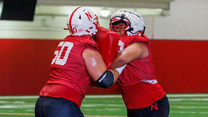Nebraska offensive lineman Rocco Spindler drives fellow lineman Houston Ka’aha’aina-Torres during a drill Monday morning.