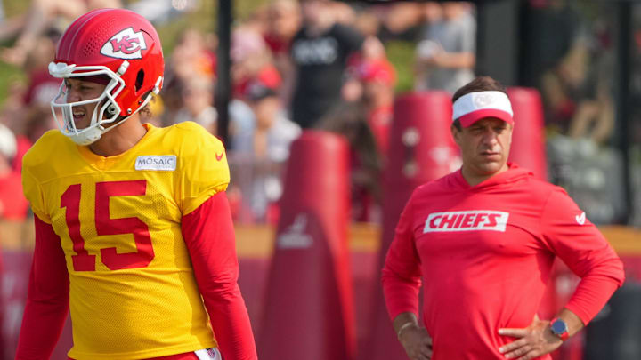 Jul 26, 2024; Kansas City, MO, USA; Kansas City Chiefs quarterback Patrick Mahomes (15) steps to the line as general manager Brett Veach watches in the background during training camp at Missouri Western State University. Mandatory Credit: Denny Medley-Imagn Images