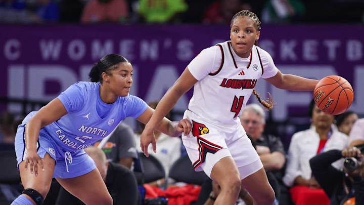 Mar 7, 2026; Duluth, GA, USA; Louisville Cardinals forward MacKenly Randolph (4) is defended by North Carolina Tar Heels forward Nyla Harris (2) in the second quarter at Gas South Arena. Mandatory Credit: Brett Davis-Imagn Images