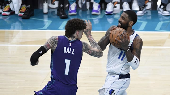 Jan 20, 2025; Charlotte, North Carolina, USA;  Dallas Mavericks guard Kyrie Irving (11) drives past Charlotte Hornets guard LaMelo Ball (1) during the second half at the Spectrum Center. Mandatory Credit: Sam Sharpe-Imagn Images