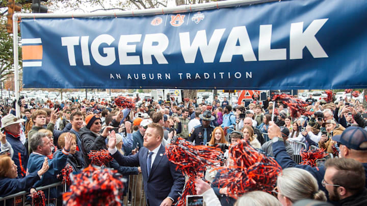Auburn football head coach Alex Golesh is welcomed during a Tiger Walk at Jordan-Hare Stadium in Auburn, Ala. on Monday, Dec. 1, 2025.