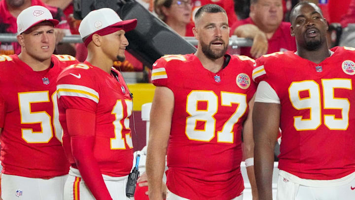 Aug 22, 2025; Kansas City, Missouri, USA; Kansas City Chiefs defensive end George Karlaftis (56) and quarterback Patrick Mahomes (15) and tight end Travis Kelce (87) and defensive tackle Chris Jones (95) watch play against the Chicago Bears during the second half of the game at GEHA Field at Arrowhead Stadium. Mandatory Credit: Denny Medley-Imagn Images