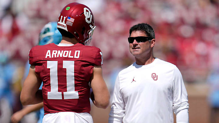 Oklahoma offensive coordinator Seth Littrell talks with quarterback Jackson Arnold.
