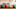 Le Creuset bean pot in blue, orange, white, and green on counter. Le Creuset bean pot in blue, orange, white, and green on counter.