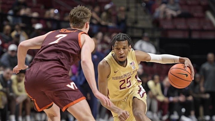 Jan 29, 2025; Tallahassee, Florida, USA; Florida State Seminoles guard Justin Thomas (25) drives to the net past Virginia Tech Hokies guard Brandon Rechsteiner (7) during the first half at Donald L. Tucker Center. Mandatory Credit: Melina Myers-Imagn Images