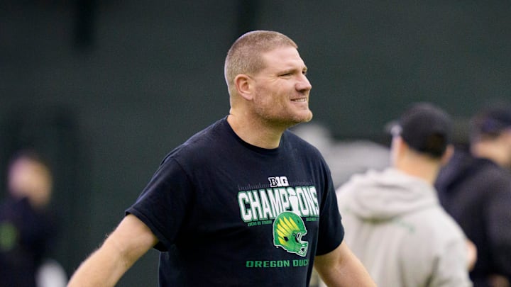 Oregon defensive coordinator Tosh Lupoi walks the field during an open practice ahead of the Orange Bowl at the Moshofsky Center in Eugene, Oregon on Dec. 27, 2025.
