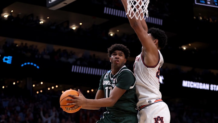 Michigan State Spartans guard Jase Richardson (11) drives against Auburn Tigers center Dylan Cardwell (44) during the second half in the South Regional final of the 2025 NCAA tournament at State Farm Arena. Michigan State Spartans guard Jase Richardson (11) drives against Auburn Tigers center Dylan Cardwell (44) during the second half in the South Regional final of the 2025 NCAA tournament at State Farm Arena.