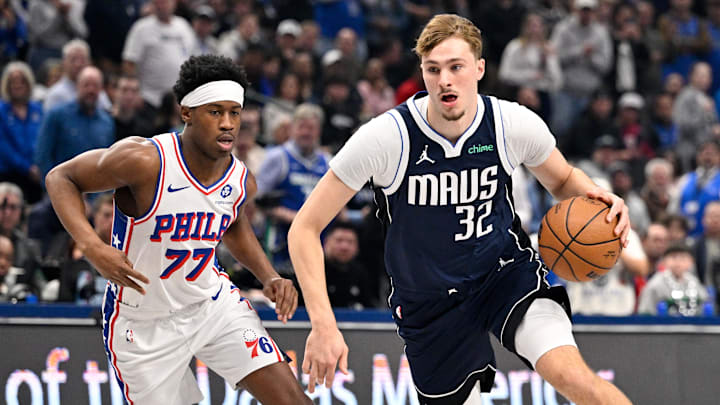 Jan 1, 2026; Dallas, Texas, USA; Dallas Mavericks forward Cooper Flagg (32) drives to the basket past Philadelphia 76ers guard Vj Edgecombe (77) during the first quarter at the American Airlines Center. Mandatory Credit: Jerome Miron-Imagn Images