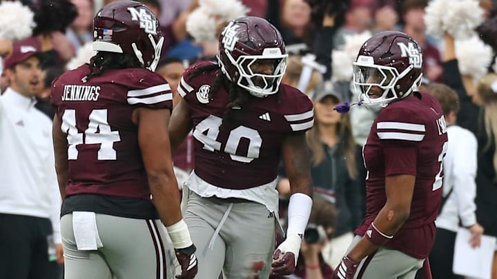 Mississippi State Bulldogs linebacker Nic Mitchell (40) reacts with linebacker Branden Jennings (44) and defensive back Isaac Smith (2) after a defensive stop during the second quarter against the Texas Longhorns at Davis Wade Stadium at Scott Field.